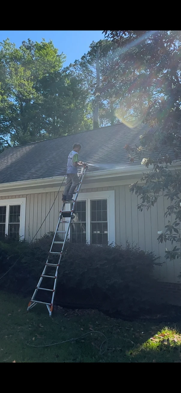 A Plus Exteriors gutter service at a residential roofline