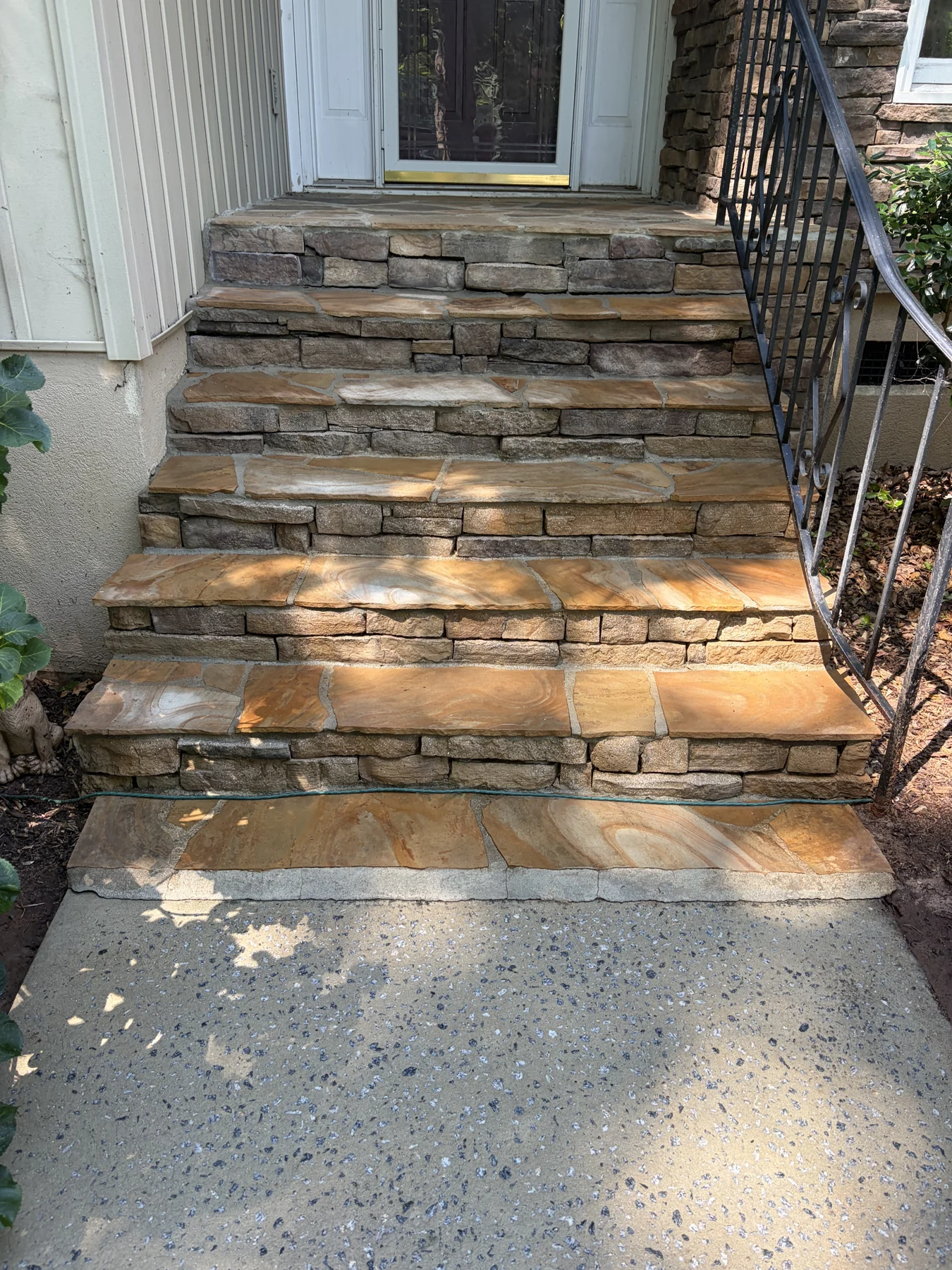 Stone front steps and concrete landing after cleaning